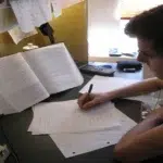 Studying with notes and textbooks.