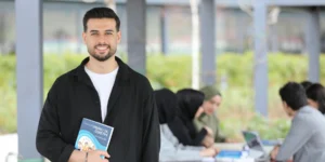 University student using an iPhone to take notes during a lecture – best note-taking app for iPhone